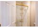 Elegant shower with glass door, gold hardware, and marble tile surround at 3935 Pierson St, Wheat Ridge, CO 80033