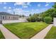 Beautiful backyard features manicured lawn, mature trees, and partial fencing at 1279 Leyden St, Denver, CO 80220