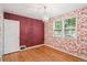 Charming bedroom featuring floral wallpaper, wood floors, and a decorative chandelier at 1279 Leyden St, Denver, CO 80220