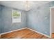 Bright bedroom features hardwood floors, a charming light fixture, and neutral walls at 1279 Leyden St, Denver, CO 80220