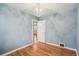 Bright bedroom features hardwood floors, a charming light fixture, and neutral walls at 1279 Leyden St, Denver, CO 80220