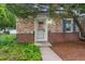 Close-up of the front door with brick accents and tidy landscaping at 1279 Leyden St, Denver, CO 80220