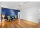 Bright living room with hardwood floors and stylish accent wall at 1279 Leyden St, Denver, CO 80220