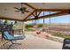 Covered outdoor patio with seating, fire pit, and landscaped backyard with a waterfall feature at 1457 Rosedale St, Castle Rock, CO 80104