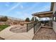 Backyard with a stone fire pit, covered patio, and lush green landscaping, perfect for outdoor gatherings at 1457 Rosedale St, Castle Rock, CO 80104