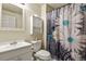 Bright bathroom featuring white vanity and cabinet, with decorative shower curtain at 1457 Rosedale St, Castle Rock, CO 80104