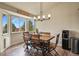 Cozy dining area with a wooden table set under a modern chandelier and bright natural lighting at 1457 Rosedale St, Castle Rock, CO 80104