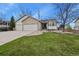 Charming home with a two-car garage, landscaped front yard, and inviting curb appeal on a sunny day at 1457 Rosedale St, Castle Rock, CO 80104