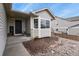Inviting front porch with decorative plants and stone accents, leading to a modern front door at 1457 Rosedale St, Castle Rock, CO 80104