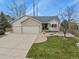 Charming home featuring a well-manicured front yard and a spacious three-car garage at 1457 Rosedale St, Castle Rock, CO 80104