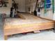 A garage featuring a ramp with wooden accents and ample storage space for bikes and tools at 1457 Rosedale St, Castle Rock, CO 80104