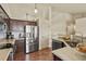 Modern kitchen with stainless steel appliances, dark wood cabinetry, and sleek countertops at 1457 Rosedale St, Castle Rock, CO 80104