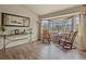 Cozy living room with large windows, rocking chairs, and natural light, perfect for relaxing at 1457 Rosedale St, Castle Rock, CO 80104
