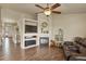 Inviting living room features a fireplace, media center, and a stylish ceiling fan at 1457 Rosedale St, Castle Rock, CO 80104