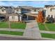An aerial perspective of a home showcasing its layout, green lawn, and proximity to neighboring houses at 515 Orion Ave, Erie, CO 80516
