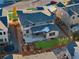 Aerial view of a backyard with a grass area, play set, covered patio, and a wooden fence surrounding the area at 515 Orion Ave, Erie, CO 80516