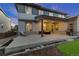 Exterior view of backyard with outdoor seating, barbecue grill, and covered patio with lighting at 515 Orion Ave, Erie, CO 80516