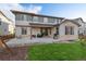 A covered patio with outdoor seating and barbecue grill, and a green lawn at 515 Orion Ave, Erie, CO 80516
