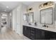 Modern bathroom with double sinks, sleek mirrors, and stylish lighting fixtures at 515 Orion Ave, Erie, CO 80516