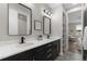 Modern bathroom with double sinks, sleek cabinetry, and contemporary lighting at 515 Orion Ave, Erie, CO 80516