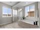 Bright bathroom with a soaking tub, walk-in shower, and stylish tile work at 515 Orion Ave, Erie, CO 80516