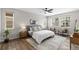 Bright bedroom with a large windows, wood floors and modern furnishings at 515 Orion Ave, Erie, CO 80516
