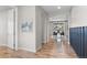 Bright entryway featuring wood floors and view of the dining area at 515 Orion Ave, Erie, CO 80516