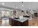 Modern kitchen features a granite island with a sink and dining space with a backyard view through sliding glass doors at 515 Orion Ave, Erie, CO 80516