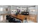 A modern open-concept kitchen features stainless appliances, sleek white cabinets, and a central island with bar seating at 515 Orion Ave, Erie, CO 80516