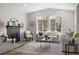 Comfortable living room featuring a brick fireplace and bright windows, creating a cozy and inviting space at 515 Orion Ave, Erie, CO 80516