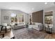 Spacious living room with accent wall, hardwood floors, and bright, natural light at 515 Orion Ave, Erie, CO 80516