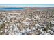 Wide aerial view of homes near a lake, snow on the ground at 10665 W 79Th Pl, Arvada, CO 80005