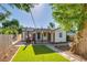 A beautiful backyard featuring an outdoor fireplace, covered patio, and artificial grass for easy maintenance at 1060 Grove St, Denver, CO 80204