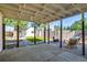 Covered outdoor patio with seating area, wood burning stove, and landscaped yard at 1060 Grove St, Denver, CO 80204