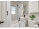 Compact bathroom with marble tile, shower-tub combo, and modern fixtures at 1060 Grove St, Denver, CO 80204