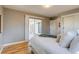 Main bedroom features hardwood floors, neutral paint colors, sliding glass doors to the patio at 1060 Grove St, Denver, CO 80204