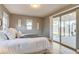 Main bedroom with wood floors, neutral paint, and sliding glass doors to the yard at 1060 Grove St, Denver, CO 80204