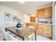 Charming eat-in kitchen with wooden cabinets and a stylish dining set at 1060 Grove St, Denver, CO 80204