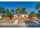View of a cozy home showcasing a modern horizontal wood fence adding privacy to the well-kept front yard at 1060 Grove St, Denver, CO 80204