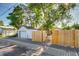 View of the detached garage, privacy fence, and side yard at 1060 Grove St, Denver, CO 80204
