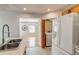 Open kitchen concept with tile floors, stainless steel sink and access to a laundry closet at 1060 Grove St, Denver, CO 80204