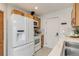 Updated kitchen features white appliances, stone counters, tile backsplash and wooden cabinets at 1060 Grove St, Denver, CO 80204
