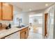 Kitchen with tile floors, stone counters, stainless steel sink and an open layout to the living area at 1060 Grove St, Denver, CO 80204