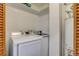 Well-lit laundry area features front load washer and dryer with shelving at 1060 Grove St, Denver, CO 80204