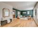Inviting living area features hardwood floors, green accent wall, and open floor plan at 1060 Grove St, Denver, CO 80204