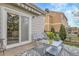 Cozy back patio with awning, seating, and flowers, perfect for outdoor relaxation at 19691 E 59Th Dr, Aurora, CO 80019