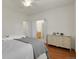 Cozy bedroom with hardwood floors, shuttered window, and furniture, including a dresser at 19691 E 59Th Dr, Aurora, CO 80019