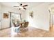 A dining room with a wooden table, four chairs, tile floor and a sliding glass door at 19691 E 59Th Dr, Aurora, CO 80019