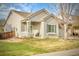Charming home featuring a covered front porch and well-maintained lawn at 19691 E 59Th Dr, Aurora, CO 80019