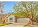 Charming home featuring a brick accent wall and a spacious two-car garage and nicely manicured front lawn at 19691 E 59Th Dr, Aurora, CO 80019